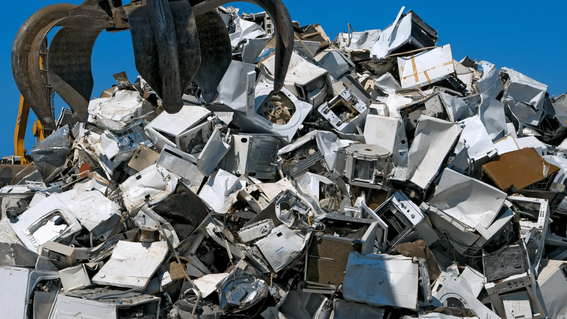 EZ-Haulin' team loading unwanted household appliances onto a truck for eco-friendly removal and disposal